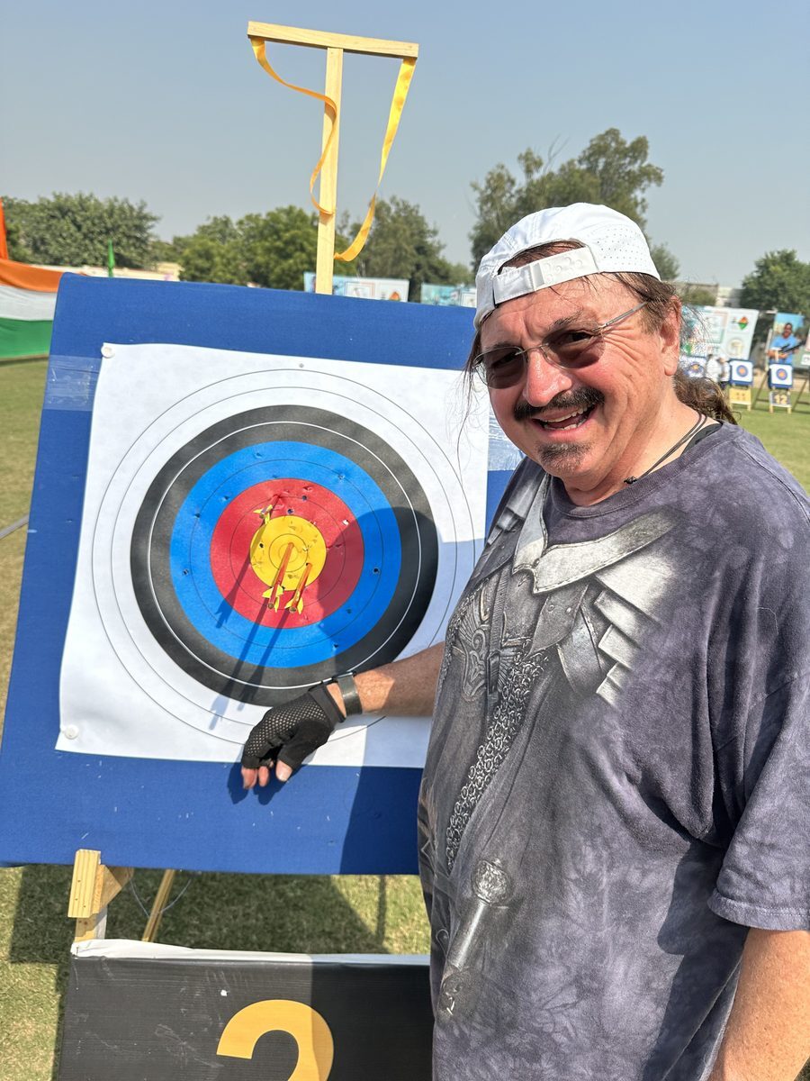 Dennis Greenaway smiling next to his target score